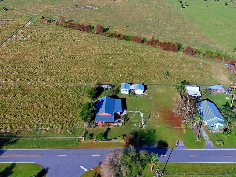 The home is on the left.  There is a horse farm behind it.