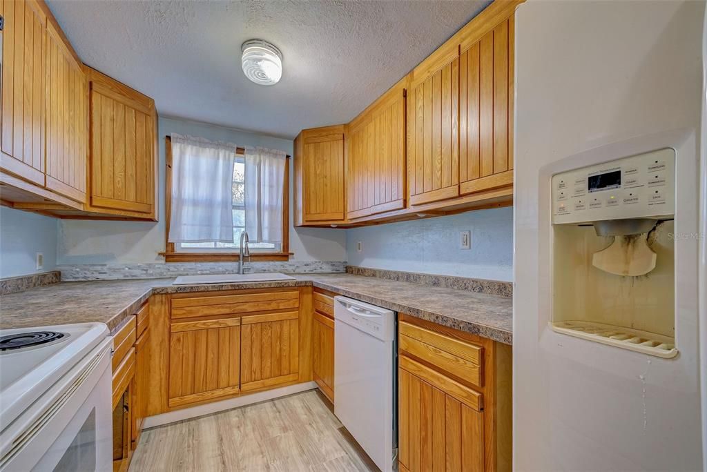 The large window in the kitchen brightens the work space.