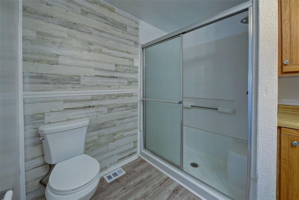 The guest bathroom has a large walk in shower.