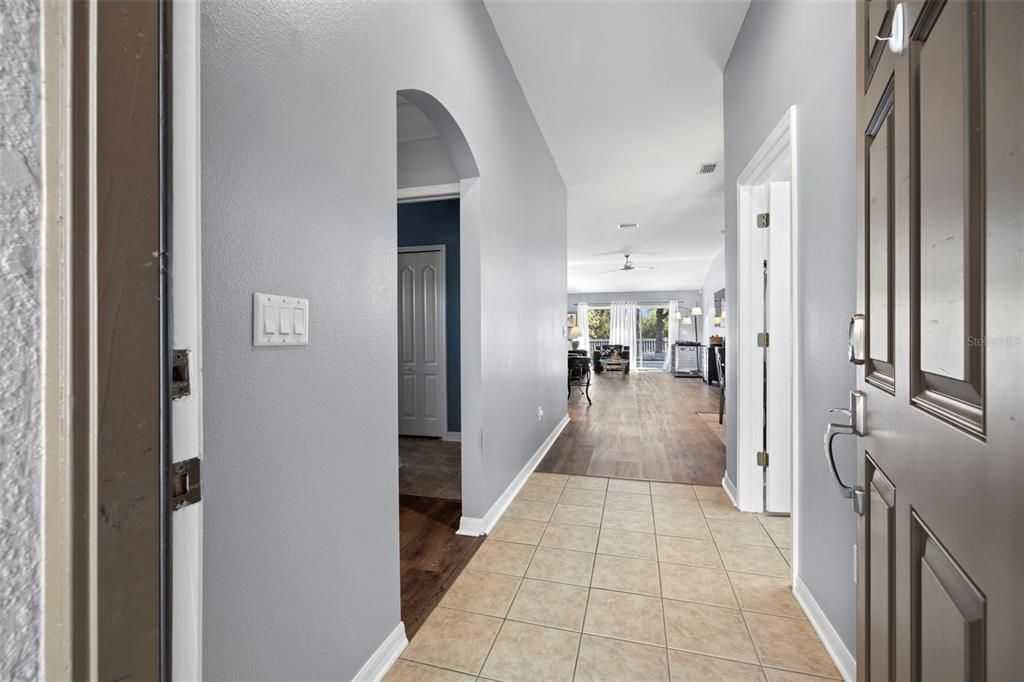 This lovely home welcomes you with a hall that leads to the main living space. Two bedrooms and a bathroom are to the left as you enter the home. The laundry room and access to the two-car garage are to the right as you walk in.