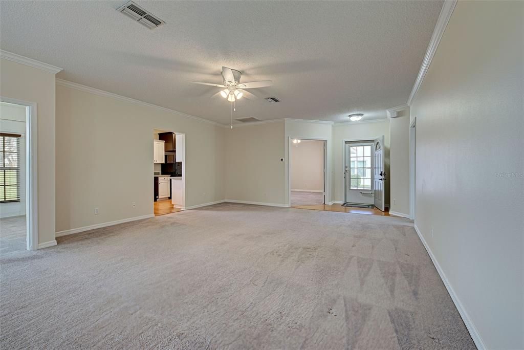 Great room with kitchen and 3rd bedroom in distance.