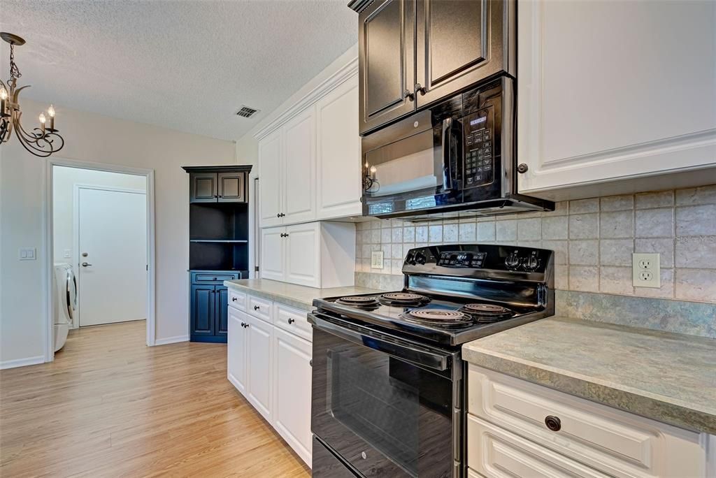 Kitchen looking into breakfast nook area, laundry room and garage.