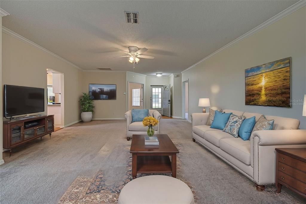 Virtually staged great room with gracious entry way and kitchen to the left.