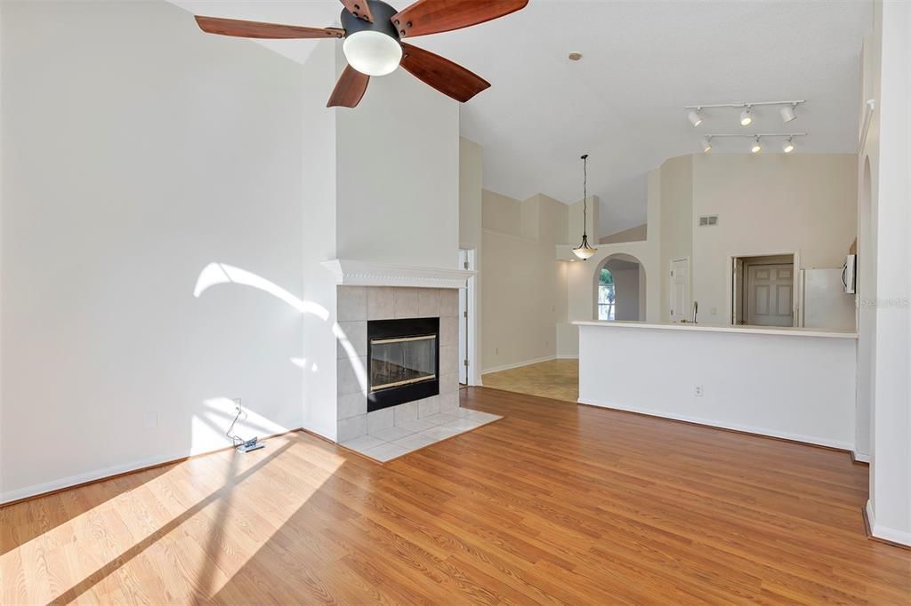 Family room view towards Fireplace and Breakfast Bar into Kitchen