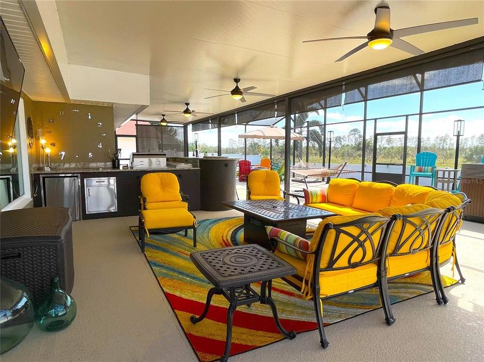 Large lanai area with ceiling fans throughout