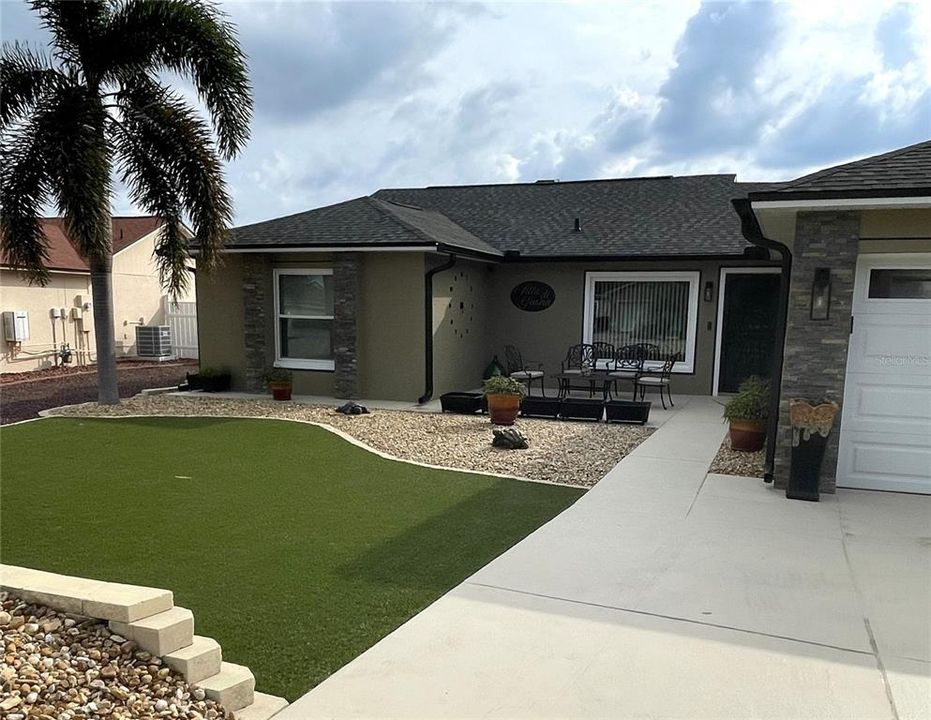 Artificial turf and xeriscaping in front yard