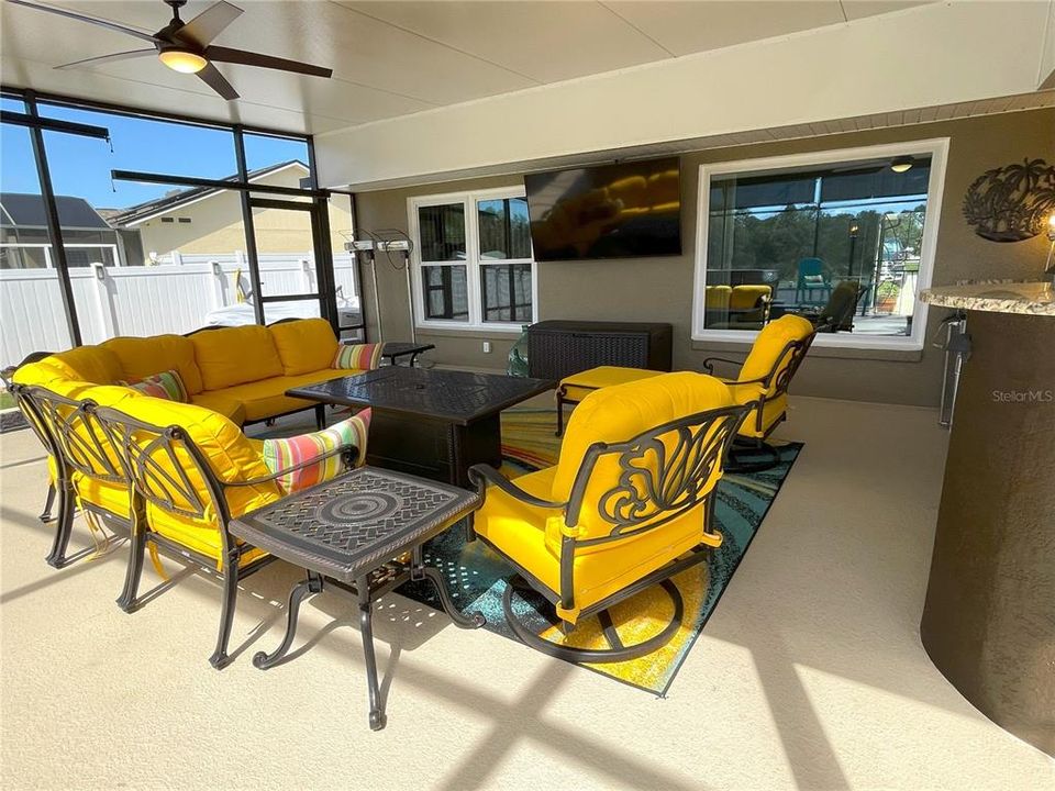 Sitting area with 70" TV, fire pit and ceiling fan