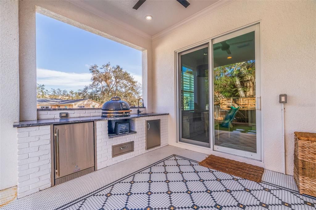 Covered outdoor kitchen conveniently located.