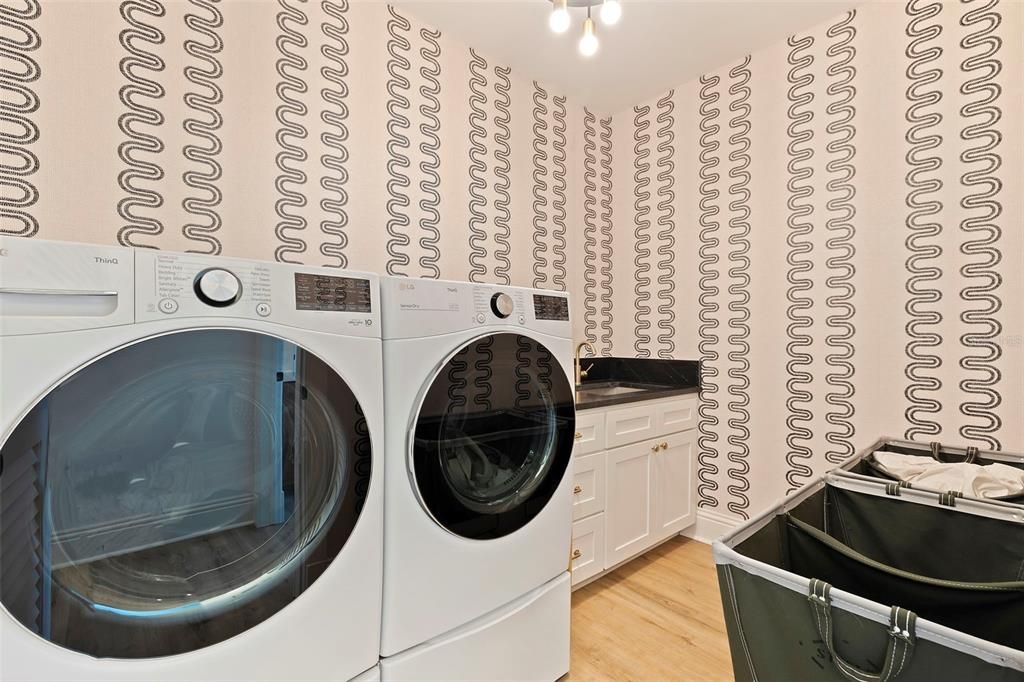 Wall paper in  this large laundry room located on 2nd Fl