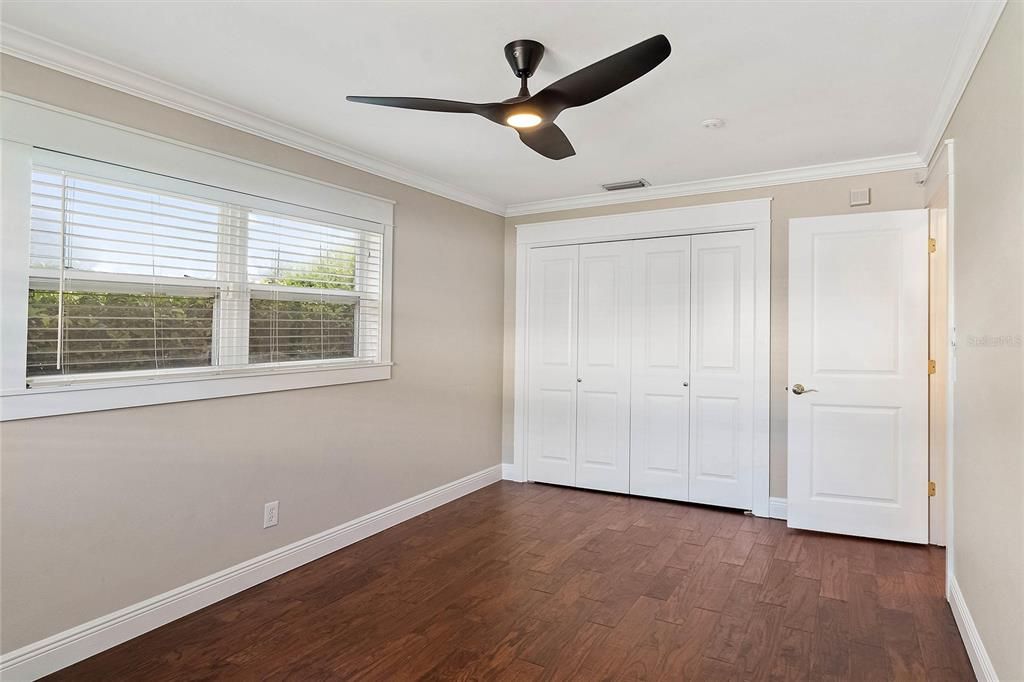 Additional view of the oversized guest room with the closet doors shut.