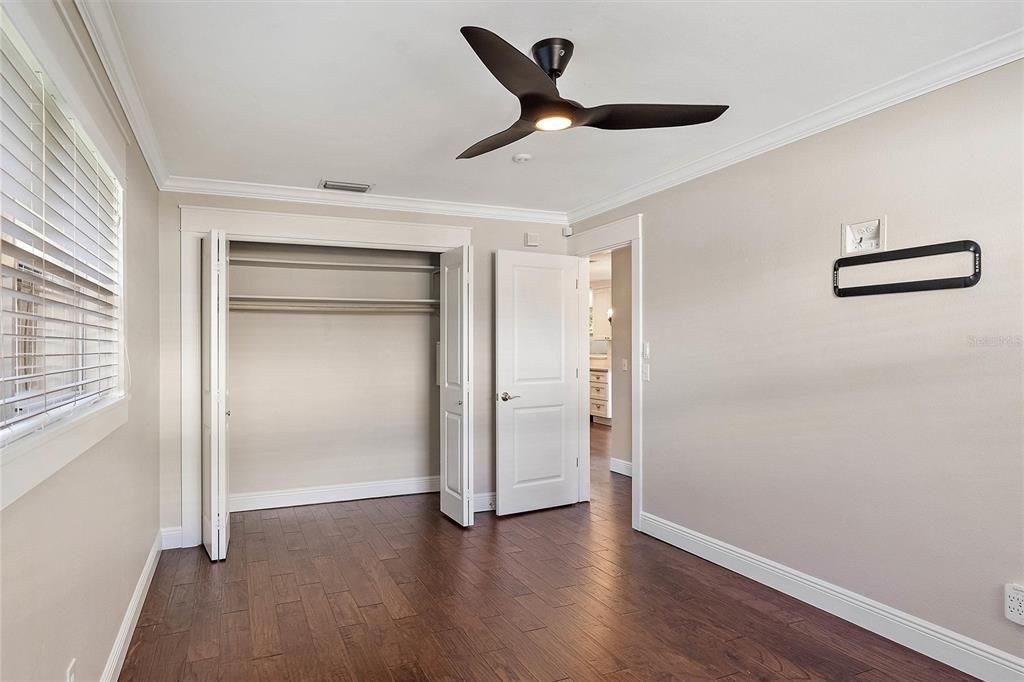 Additional view of the oversized guest room with the closet doors shut.