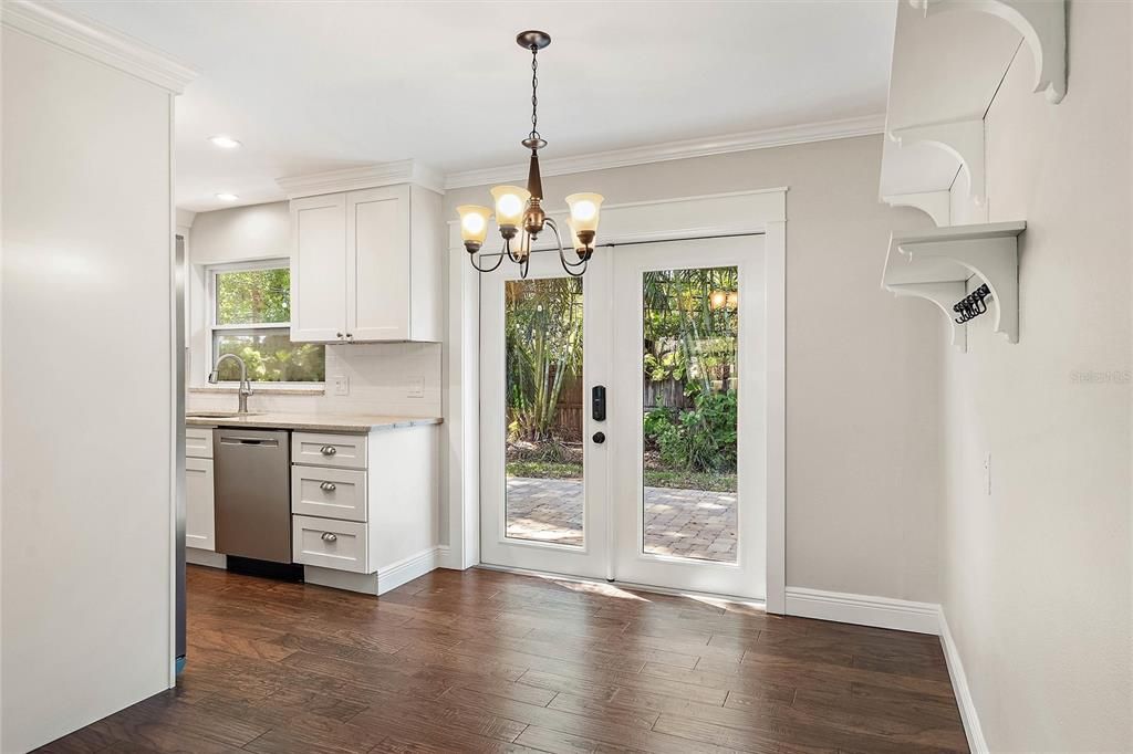 Dining and kitchen areas with French doors leading to the backyard.