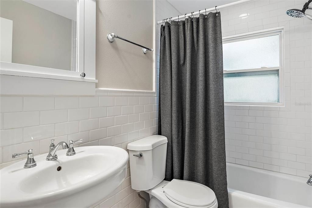 Full guest bathroom with combination shower/tub.