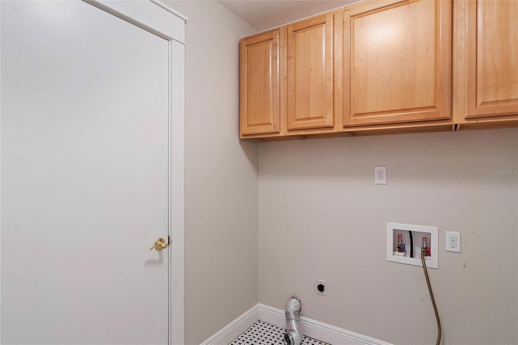 Indoor laundry room with storage.