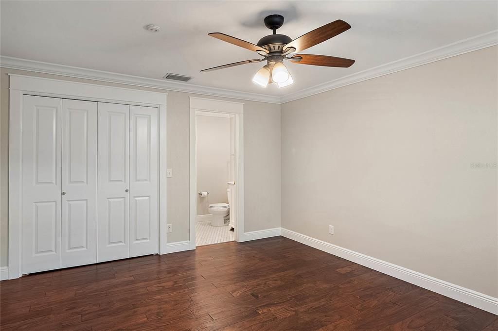 View of the primary bedroom with the closet doors shut.