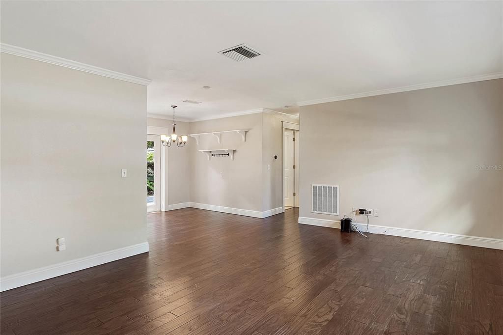 Additional view of the large living area from the front door and laundry room entrance.