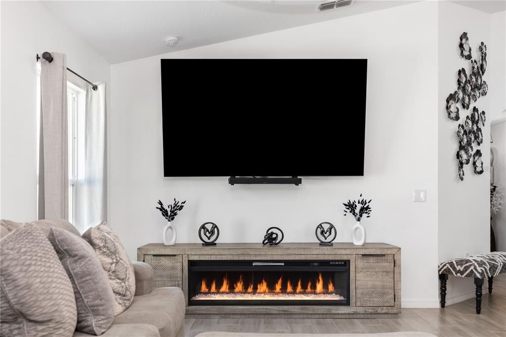 Living room with fireplace and TV