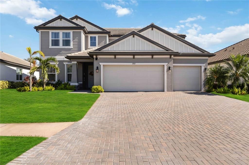 Front of Home with 3 car Garage, and covered Entryway