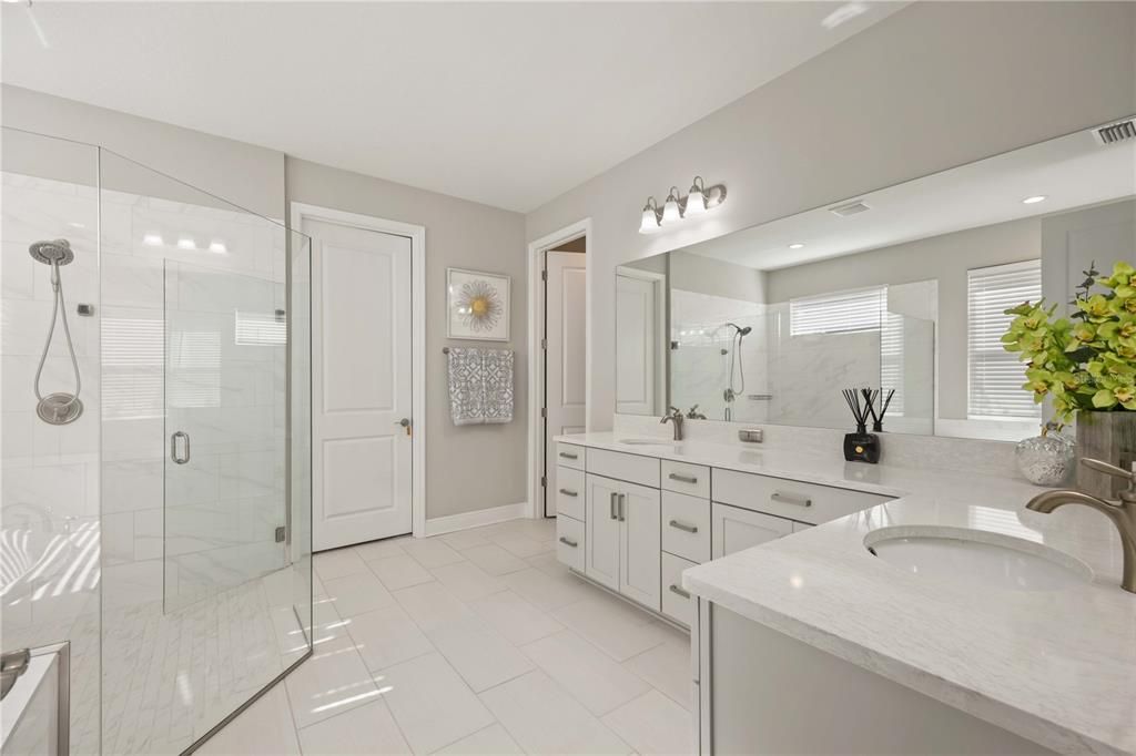 Esuite Bathroom with double vanities, water closet, walk-in closet