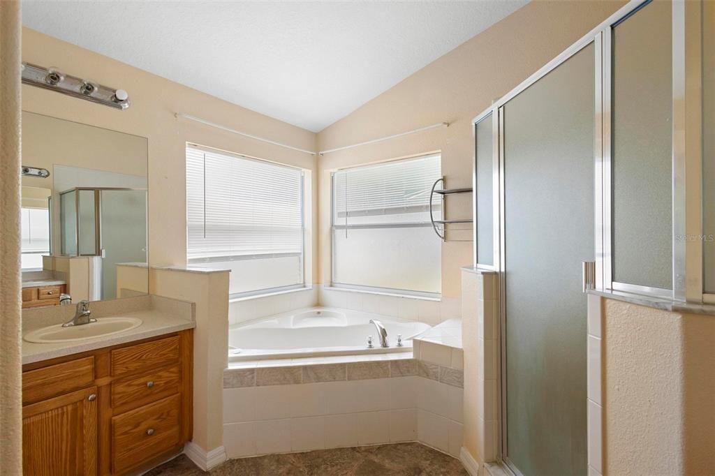 Primary Bathroom with Garden Tub walk in Shower and 2 Vanities