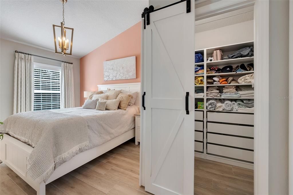 Primary Bedroom with Barn Doors to Customized Walk-in Closet