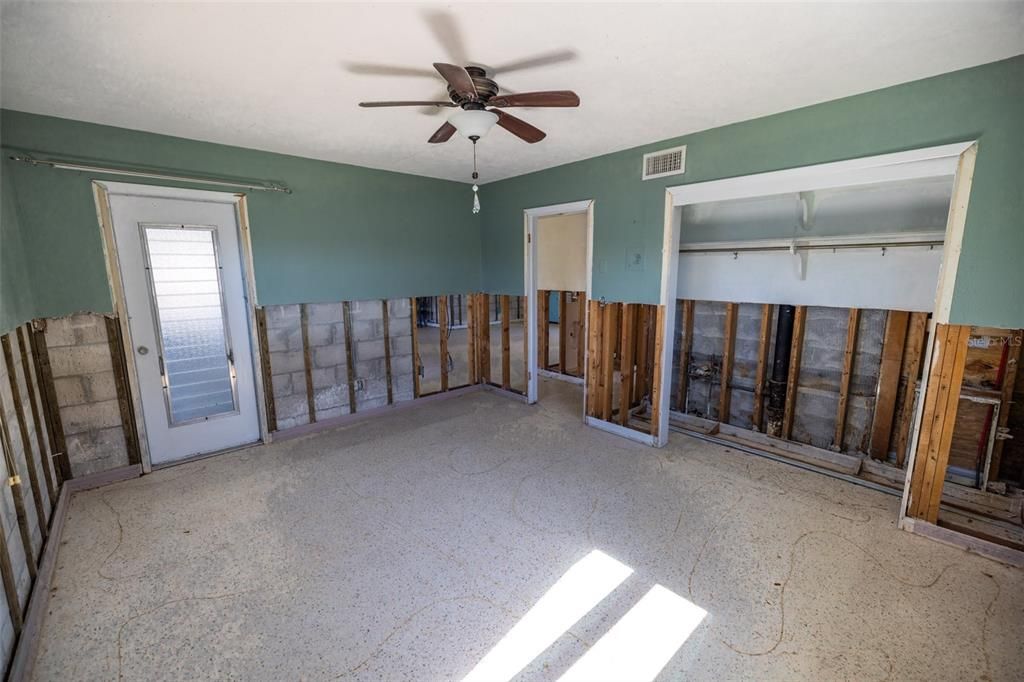 Master bedroom with door to backyard screened porch.