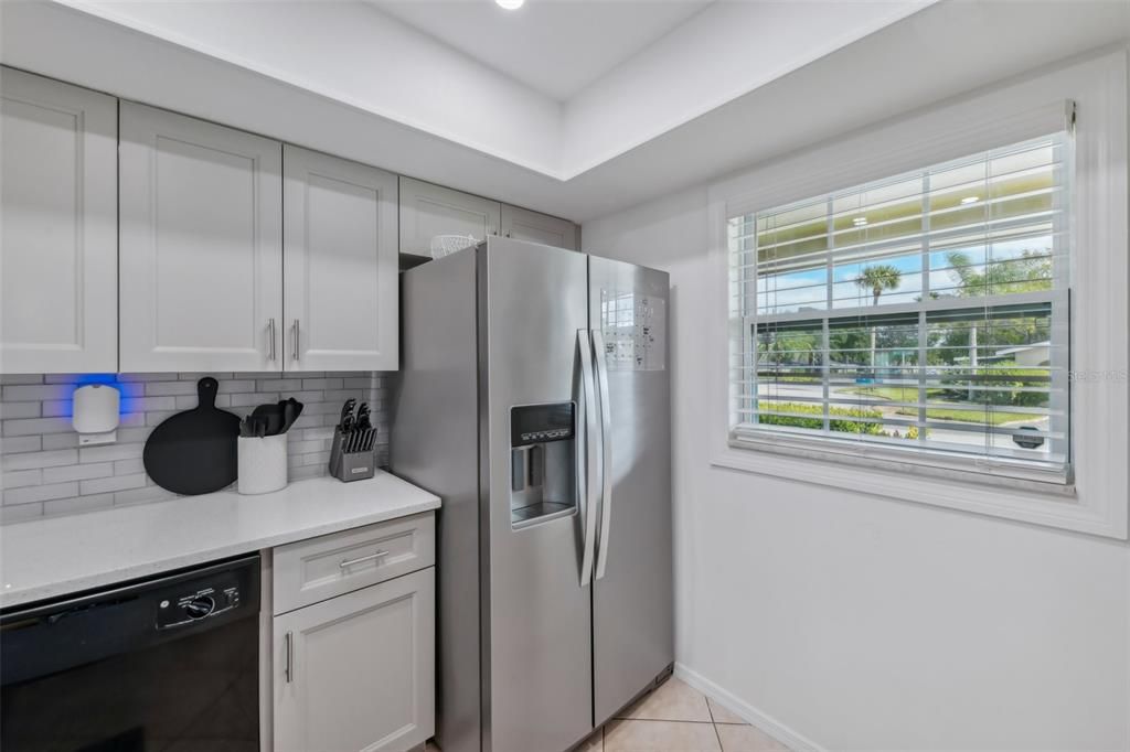 COMPLETE KITCHEN REMODEL with HIGH-END QUARTZ COUNTERTOPS, TILE BACKSPLASH, ALL NEW CABINETS, SUNKEN SINK, UPDATED RANGE, REFRIGERATOR, MICROWAVE AND CUSTOM LIGHTING!