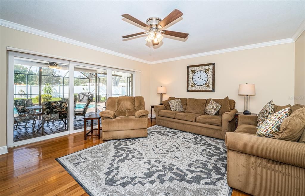 Living Room with wood floors and pool view