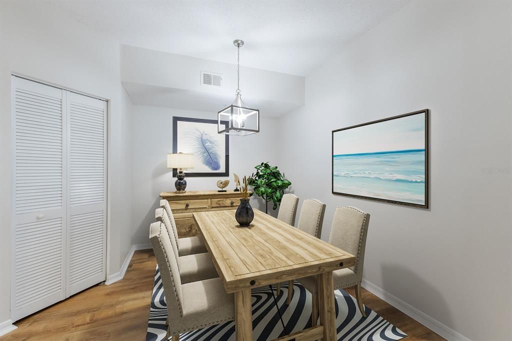 Staged -Lovely Dining space with stylish Luxury Vinyl Plank Flooring, fresh neutral paint & new light fixture!