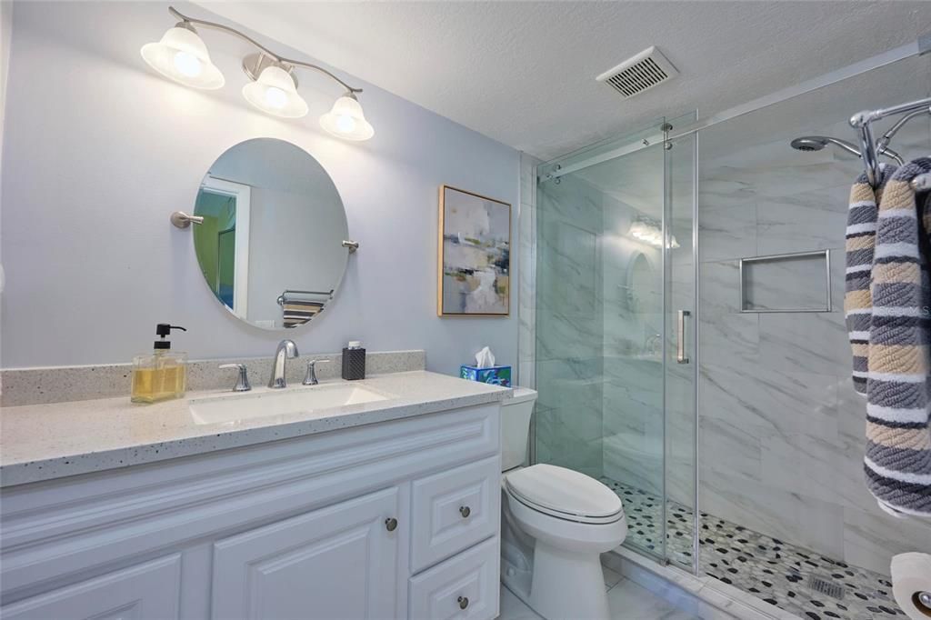 Quartz countertops and elegant tile in the master bathroom