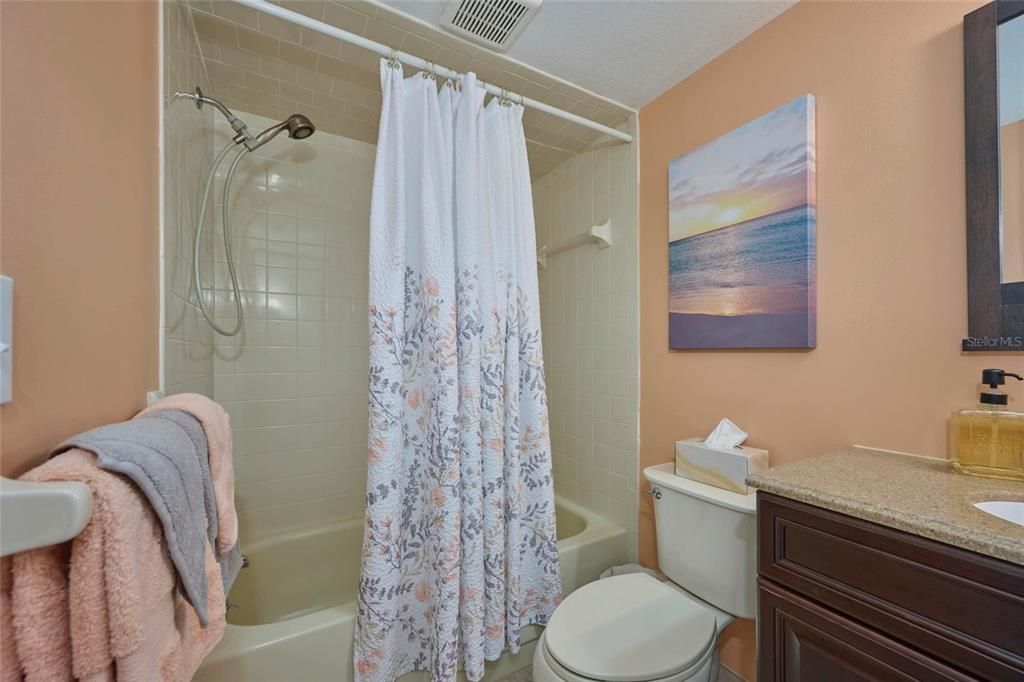 Guest bathroom offers a tub/shower combo