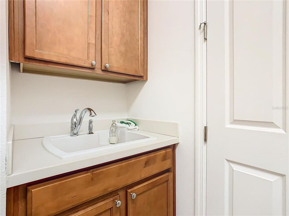 UTILITY SINK AND STORAGE IN LAUNDRY ROOM