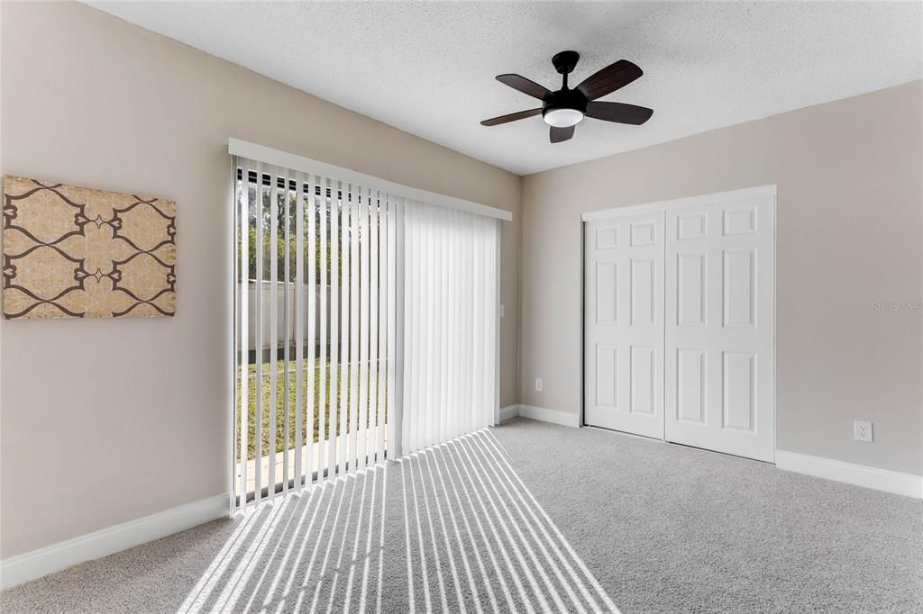 Flex room with sliding doors to the backyard and closet