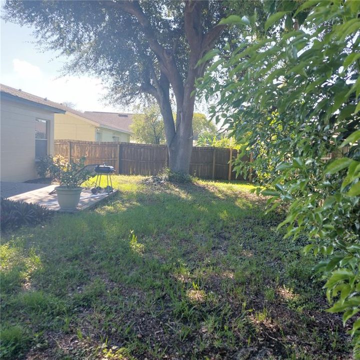 looking across rear yard, fenced and with large deck