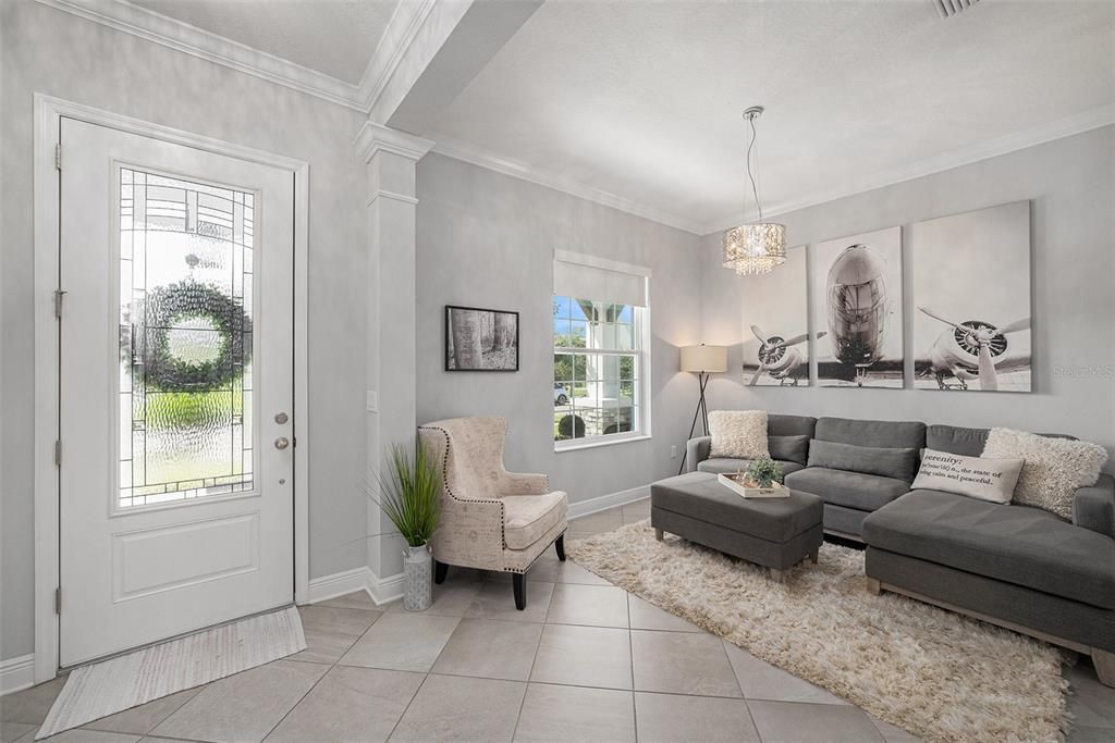 The inviting foyer spills into this fabulous flex space