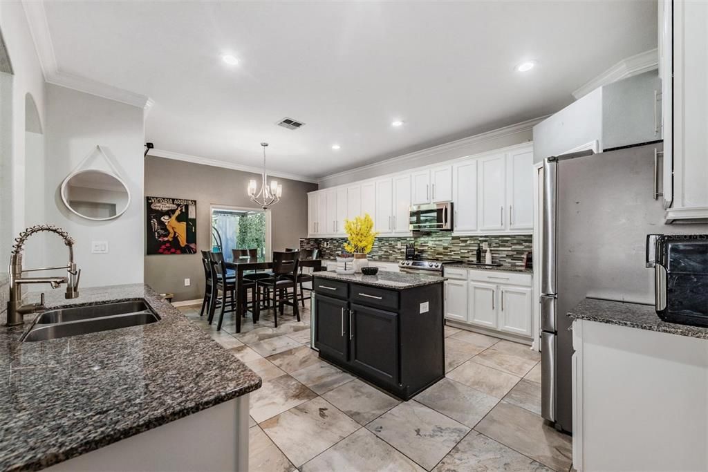 Updated kitchen, with granite counter tops, new backsplash, new appliances, lots of cabinets and a closet pantry.