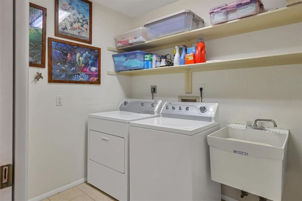 Indoor laundry room with sink