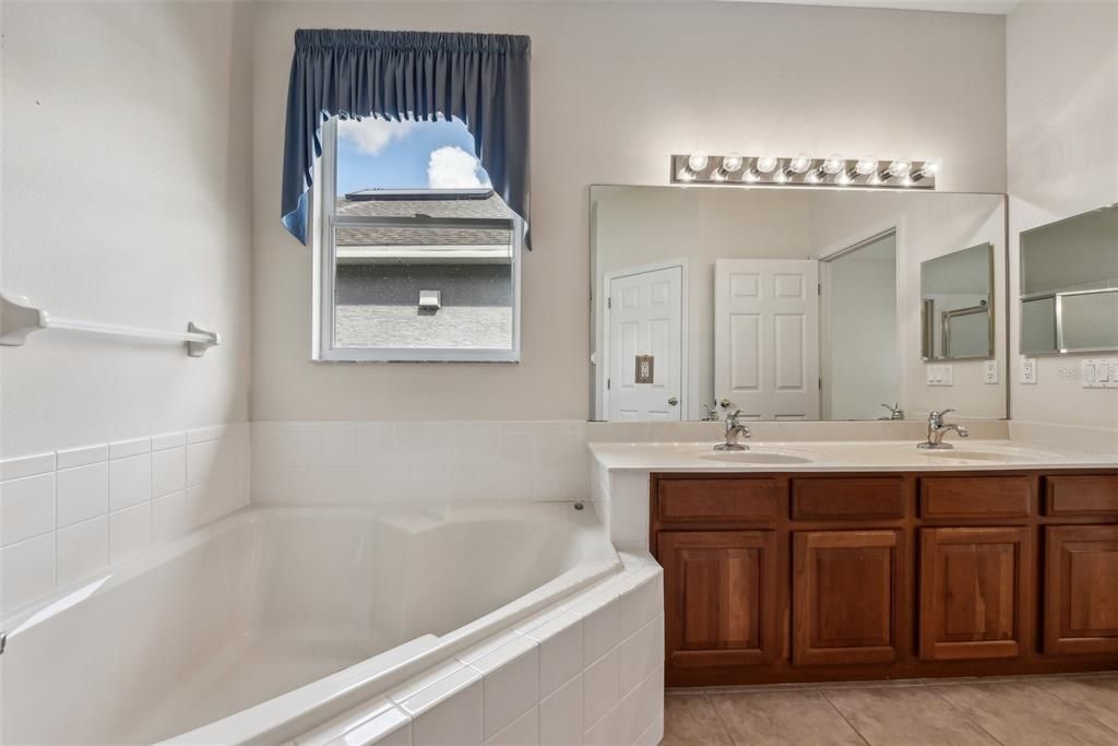 Large Primary Bathroom with Double Vanity, Garden Tub, Stand Up Shower, Water Closet and Natural Light!