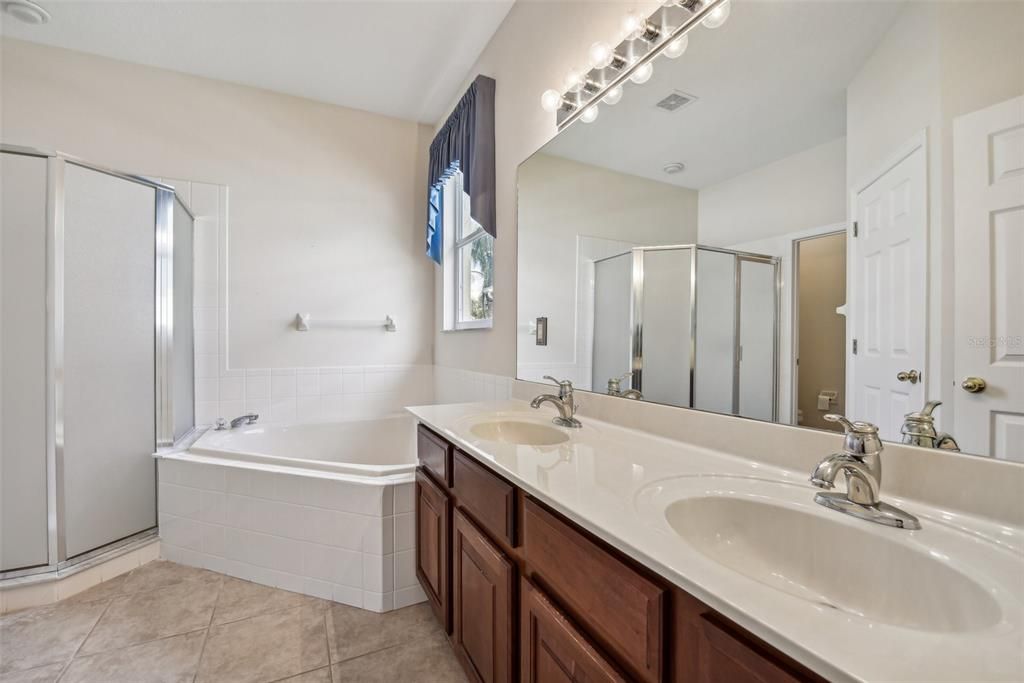 Large Primary Bathroom with Double Vanity, Garden Tub, Stand Up Shower, Water Closet and Natural Light!