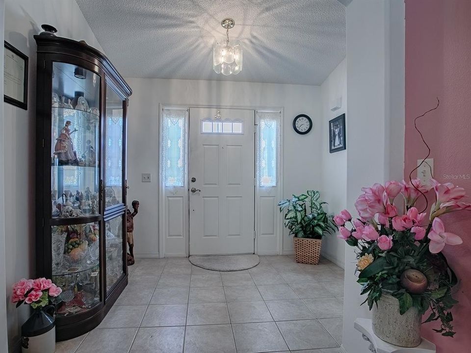 GORGEOUS LEADED GLASS ACCENTS LET IN PLENTY OF NATURAL LIGHT IN THE FOYER