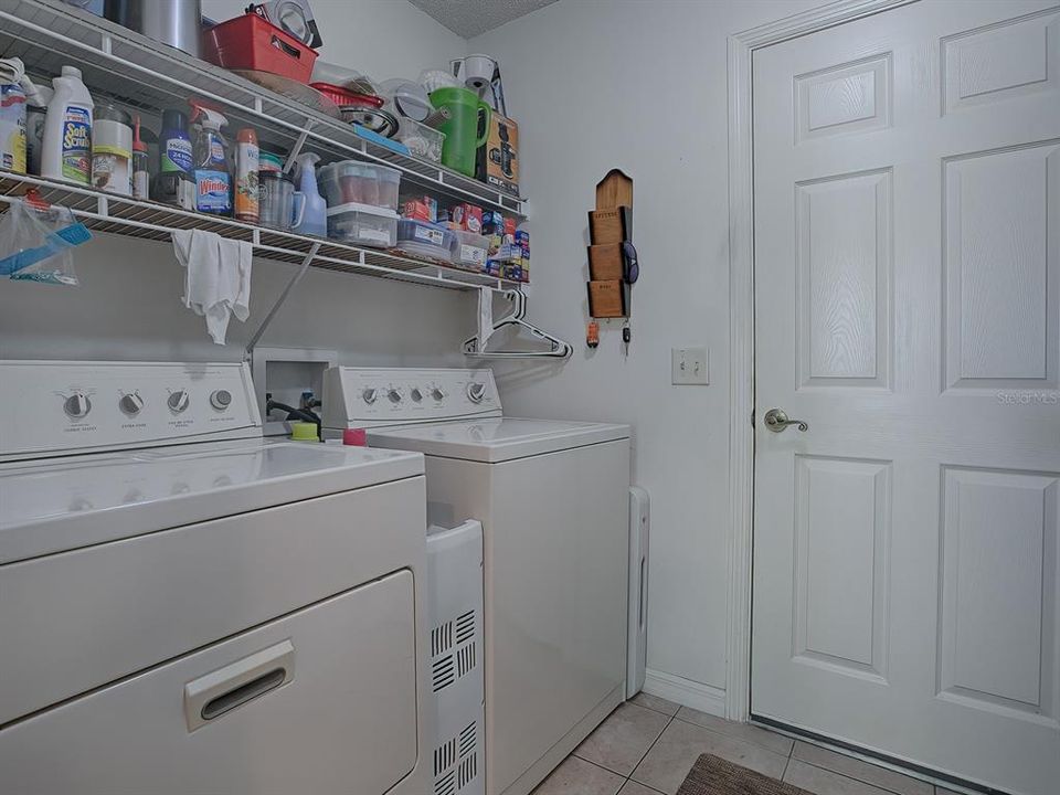 LAUNDRY ROOM HAS PLENTY OF SHELVING AND STORAGE SPACE