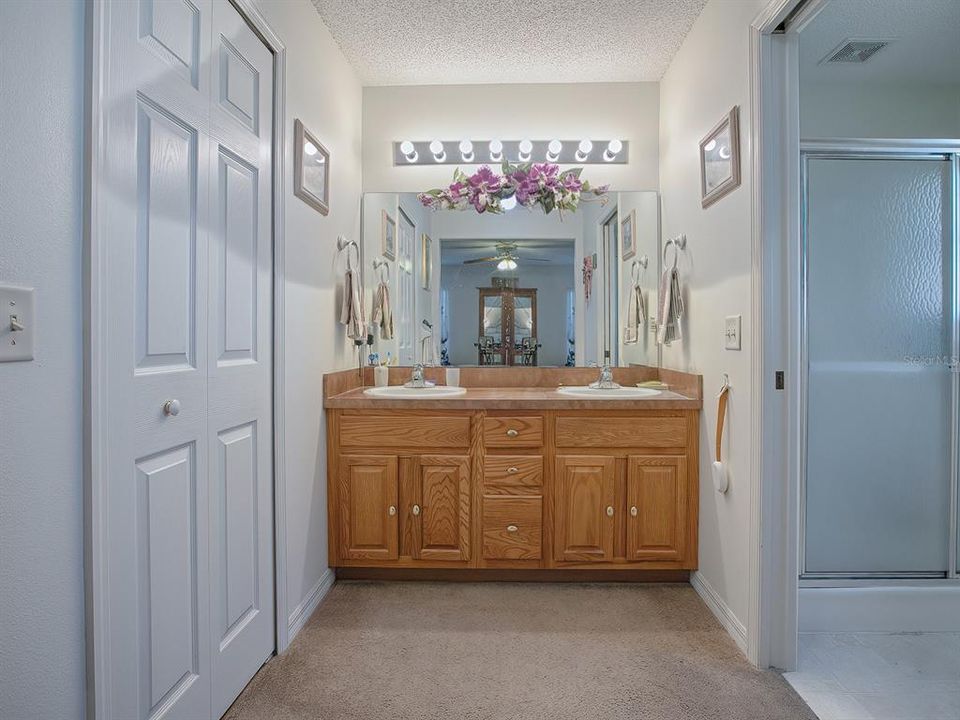 DUAL SINKS, PLENTY OF CLOSET SPACE AND SEPARATE TOILET ROOM WITH SLIDING POCKET DOOR