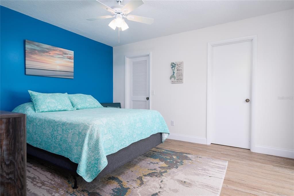 Primary bedroom towards walk-in closet (left) and private bath (right).