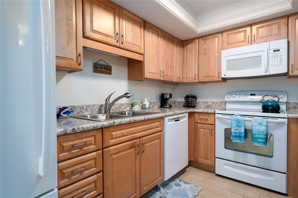 The newer kitchen includes soft close cabinetry and space-saving undercabinet slideouts.