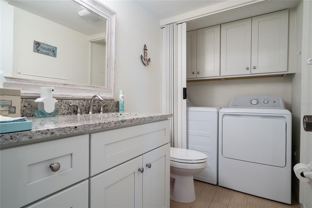 First floor bath with laundry doors open.