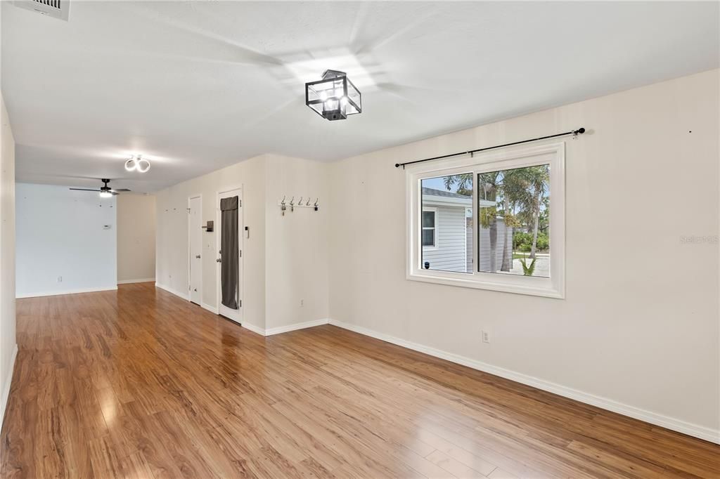 Dining room with chandelier and plenty of room for larger dining tables and china cabinet.