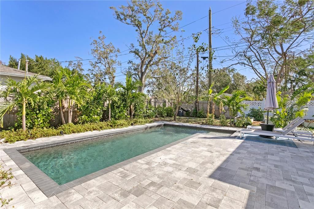 Pool area with tropical landscaping