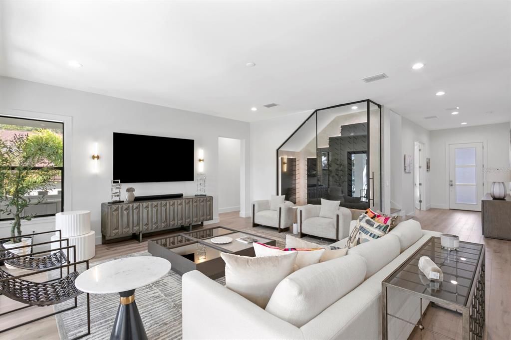 Great room with high ceiling and wide plank wood flooring!