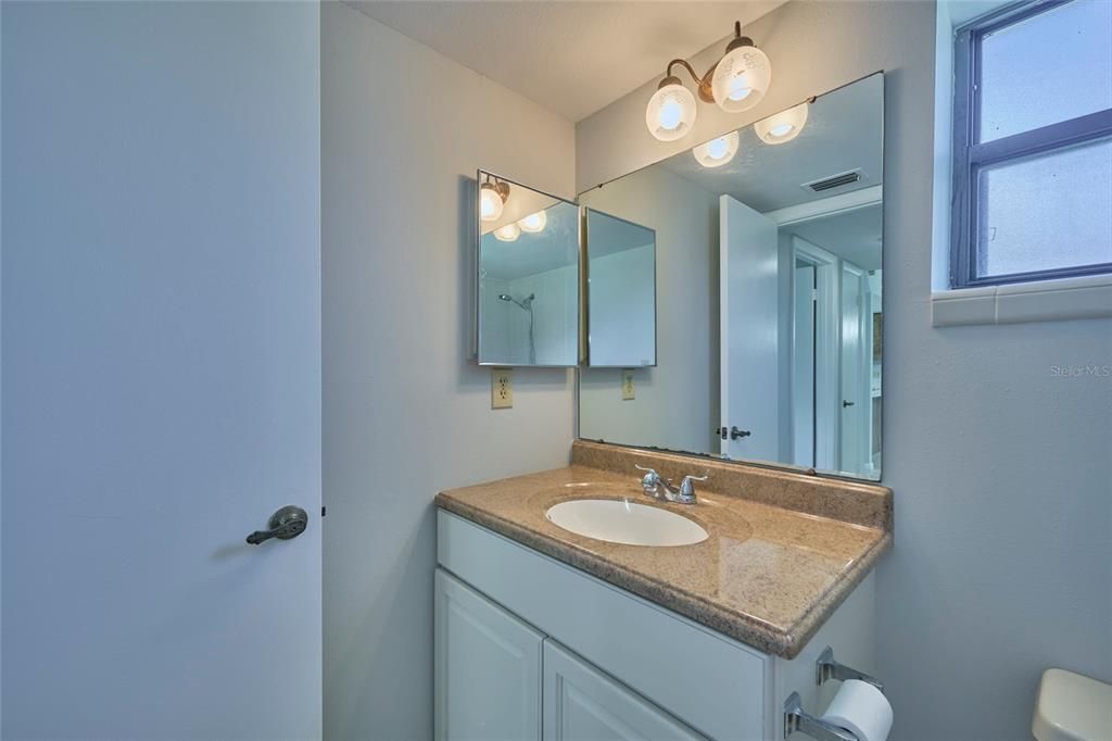 Guest bathroom with solid surface countertops