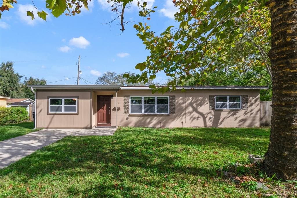 UPDATED BLOCK HOME close to Lake Underhill and Downtown Orlando with a NEW ROOF (2024), NEW WINDOWS (2024), UPDATED SEPTIC DRAIN FIELD, RENOVATED KITCHEN & PRIMARY BATH, a large FENCED YARD and NO HOA!